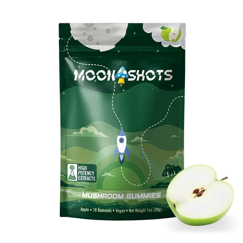 Moonshots magic mushroom gummies packaging with a half-apple lying next to it.