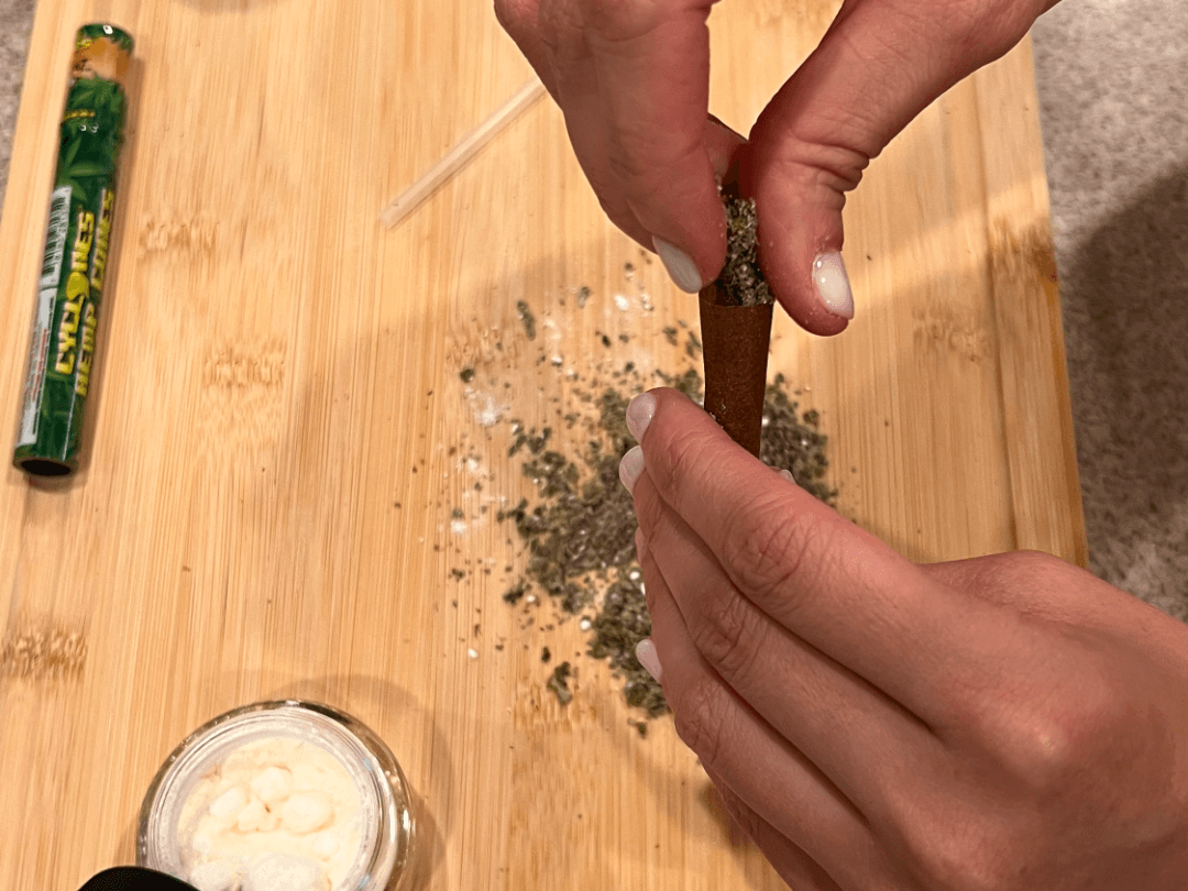 adding your THCA canabis mix to your blunt is another step in the process of how to roll a blunt using THCA crystals